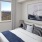 rendering of bedroom showing natural light through window and large open space for bed and furniture