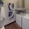 laundry room with shelf, and water heater above the dryer unit