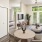 An image showing a furnished living room that looks into the bedroom